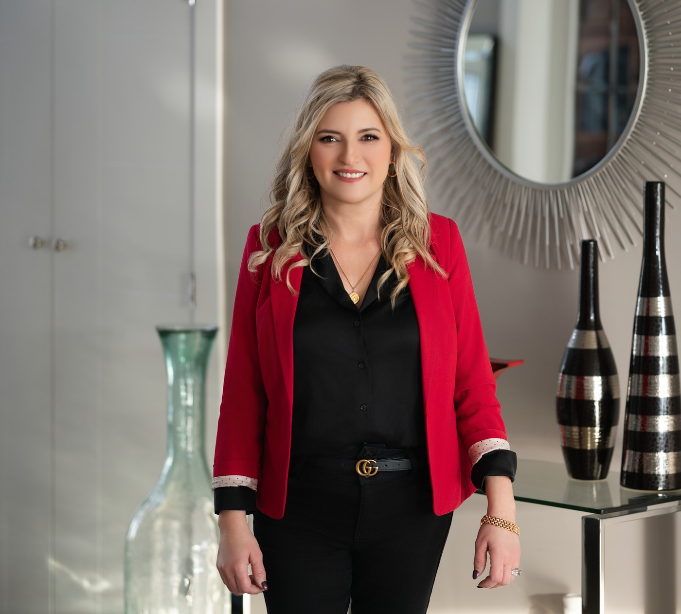 Faye Domingues, realtor, in a red blazer